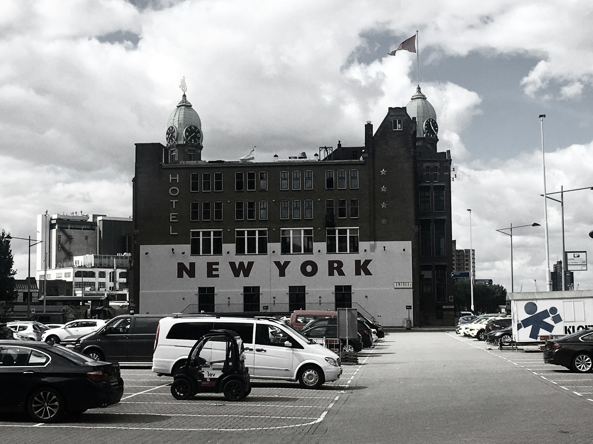 cars parked in front of brown building during daytime